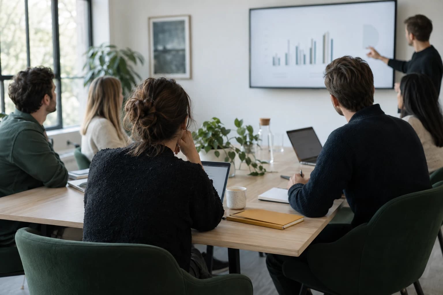 An SEO team in a GEO training workshop, following a trainer's chart on a wall screen