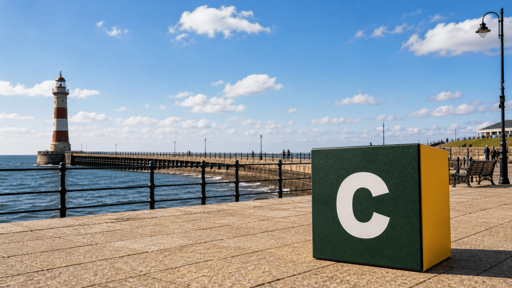 AI training in Sunderland with a realistic Coaley Peak branded 3D cube at Roker Pier and lighthouse